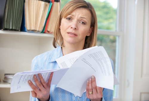 Woman overwhelmed by bills needing tips on frugal living